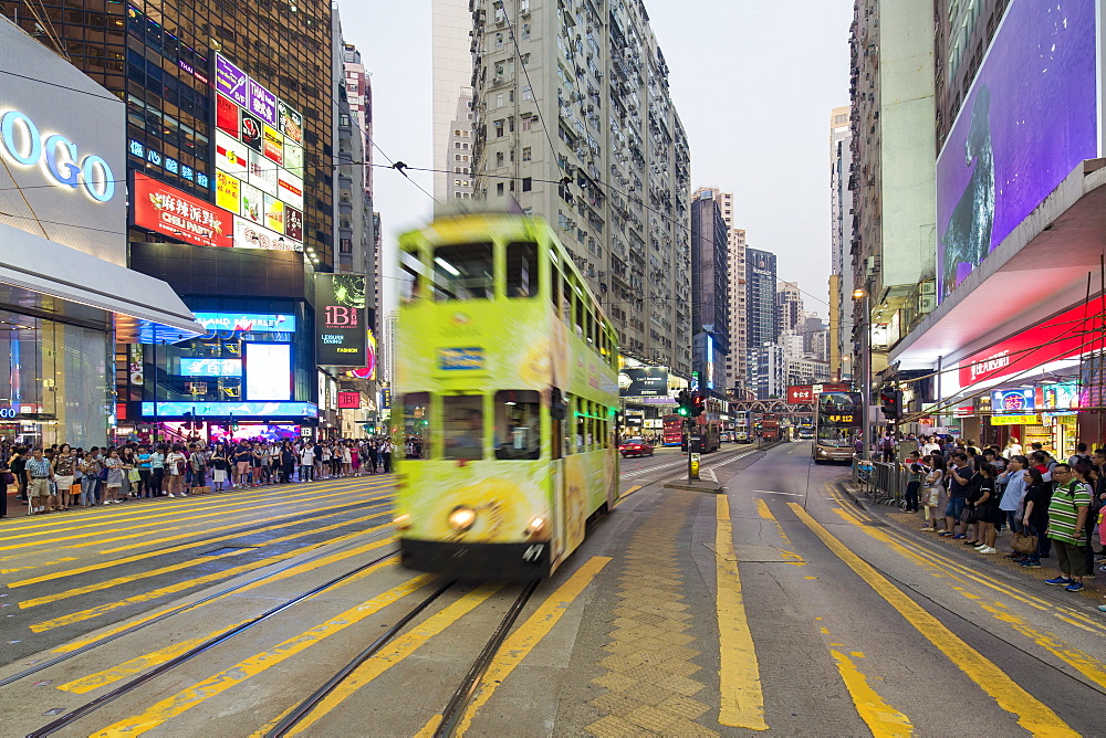 Pedestrians and traffic at a busy road crossing in Causeway Bay, Hong Kong Island, Hong Kong, China, Asia