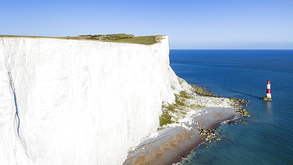 White chalk cliffs of Beachy Head and lighthouse, South Downs National Park, near Eastbourne, East Sussex, England, United Kingdom, Europe (Drone)