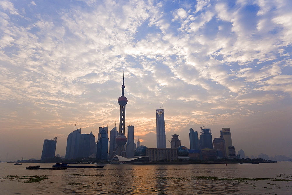 View of Oriental Pearl TV Tower and highrises in the Pudong New Area viewed across the Huangpu River from the Bund, Shanghai, China, Asia