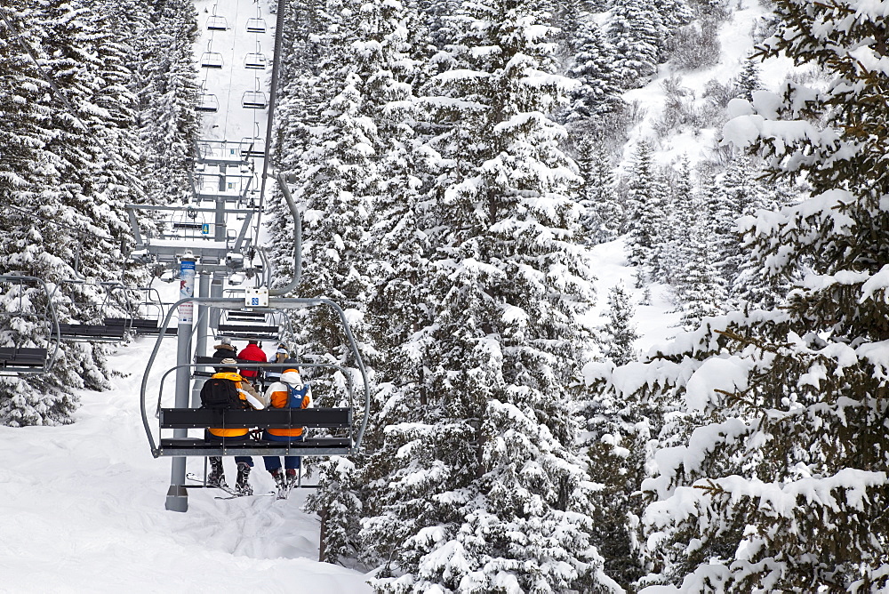 Skiers on a chairlift, Meribel ski resort in the Three Valleys (Les Trois Vallees), Savoie, French Alps, France, Europe