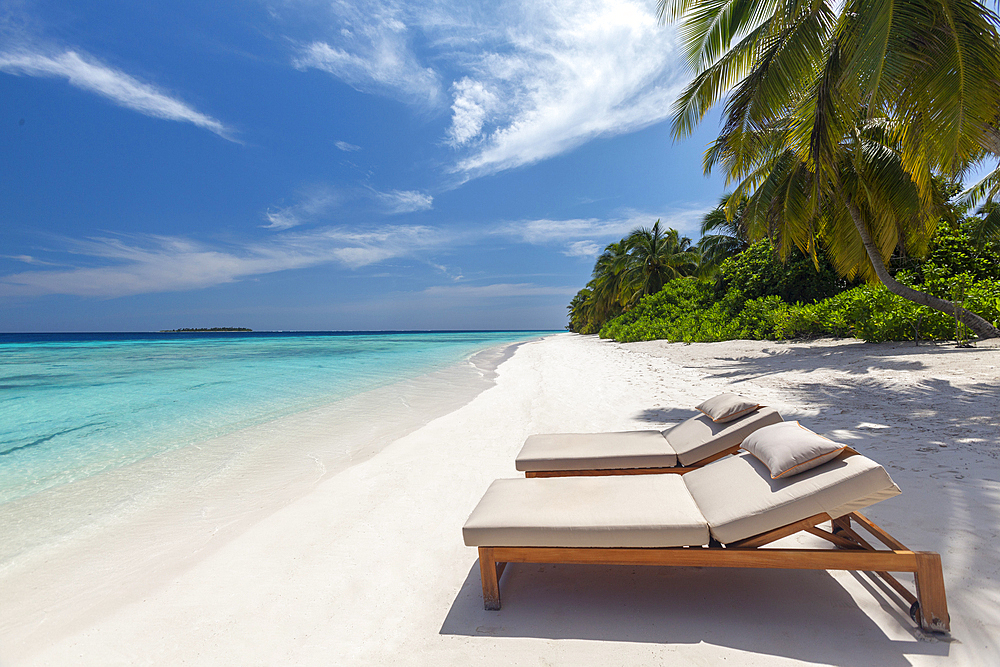 Wooden lounge chairs on a beautiful tropical beach, The Maldives, Indian Ocean, Asia