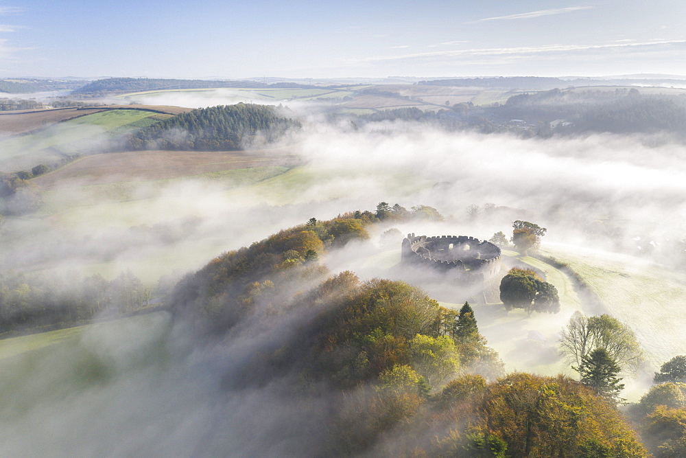 Aerial view by drone of autumn mist swirling above Restormel Castle in Cornwall, United Kingdom, Europe