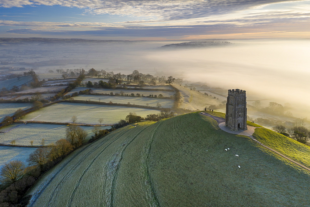 Aerial view by drone of frosty winter morning at Glastonbury Tor, Somerset, England, United Kingdom, Europe