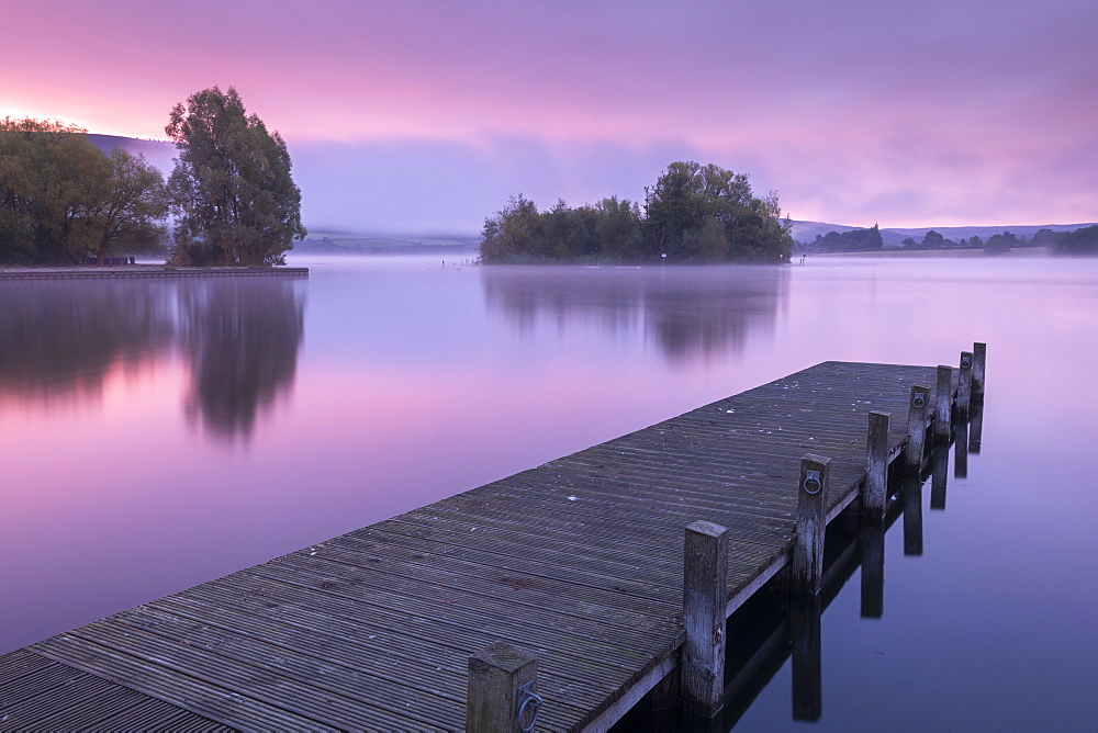 Pink sunrise over Llangorse Lake in the Brecon Beacons National Park, Powys, Wales, United Kingdom, Europe