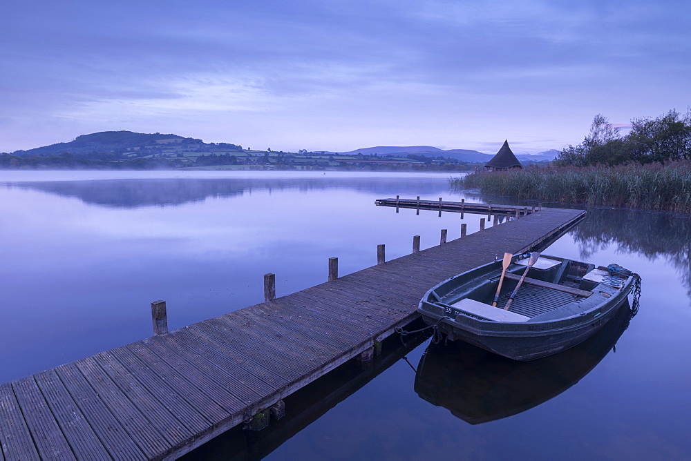 Moored boat on a wooden jetty on Llangorse Lake, Brecon Beacons, Powys, Wales, United Kingdom, Europe