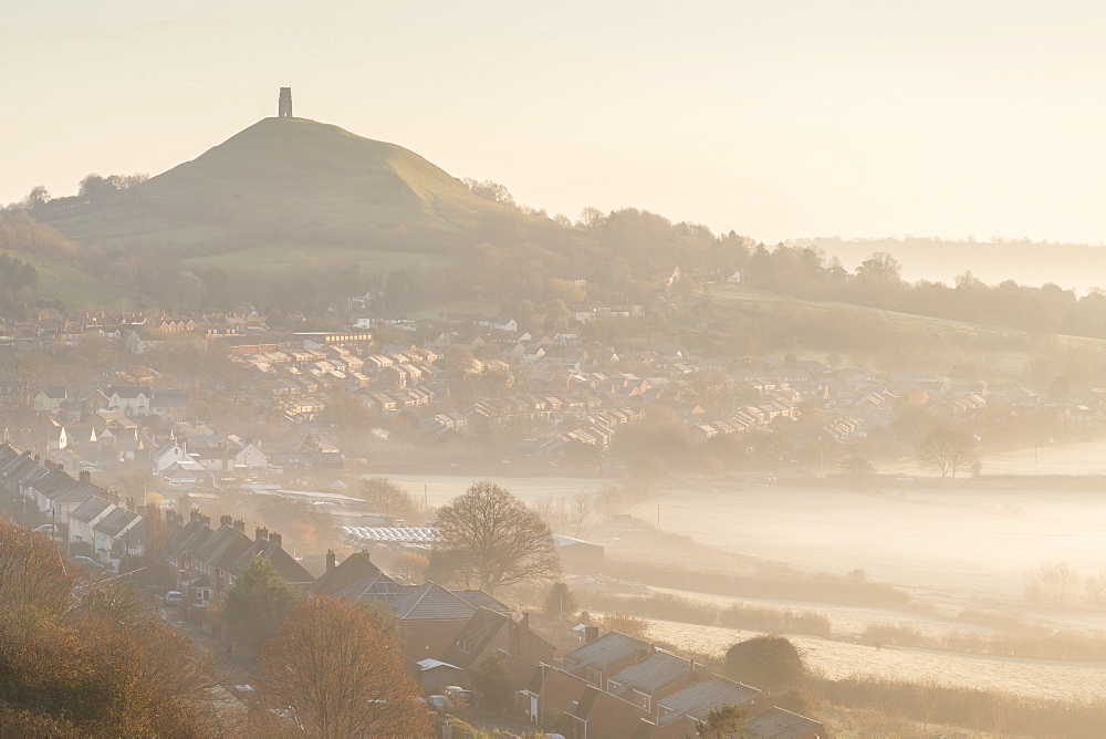 Vista over Glastonbury towards Glastonbury Tor on a misty winter morning, Somerset, England, United Kingdom, Europe