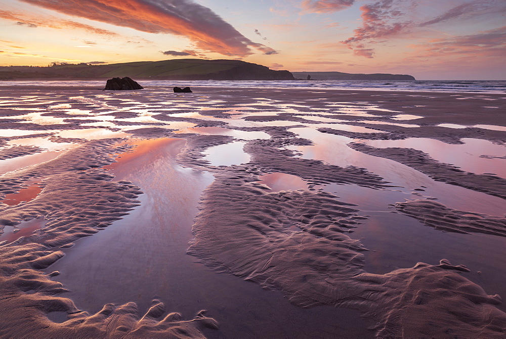 Pink sunrise skies in winter above the sandy beach at Bigbury-on-Sea, South Hams, Devon, England, United Kingdom, Europe