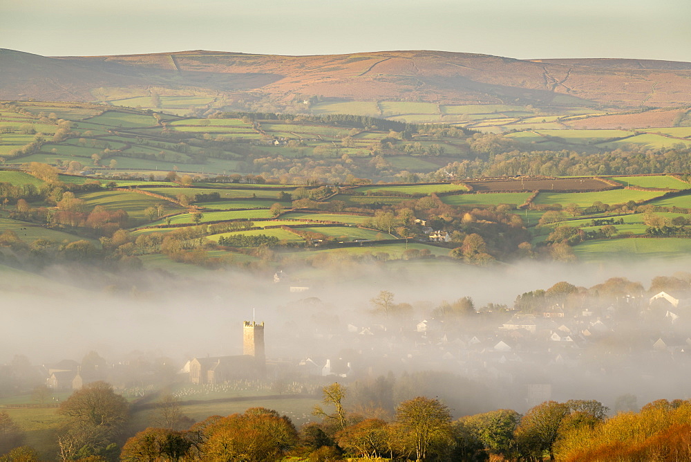 Misty winter morning view towards the church and Dartmoor village of Moretonhampstead, Devon, England, United Kingdom, Europe