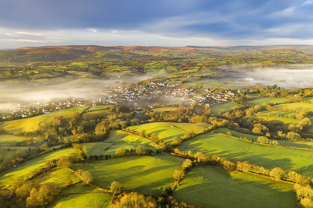 Aerial vista by drone of rolling countryside surrounding the village of Moretonhamstead in winter, Devon, England, United Kingdom, Europe