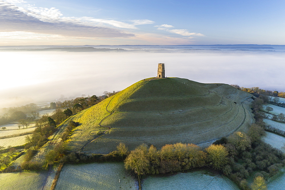 View by drone of St. Michael's Tower on Glastonbury Tor at dawn in winter, Somerset, England, United Kingdom, Europe