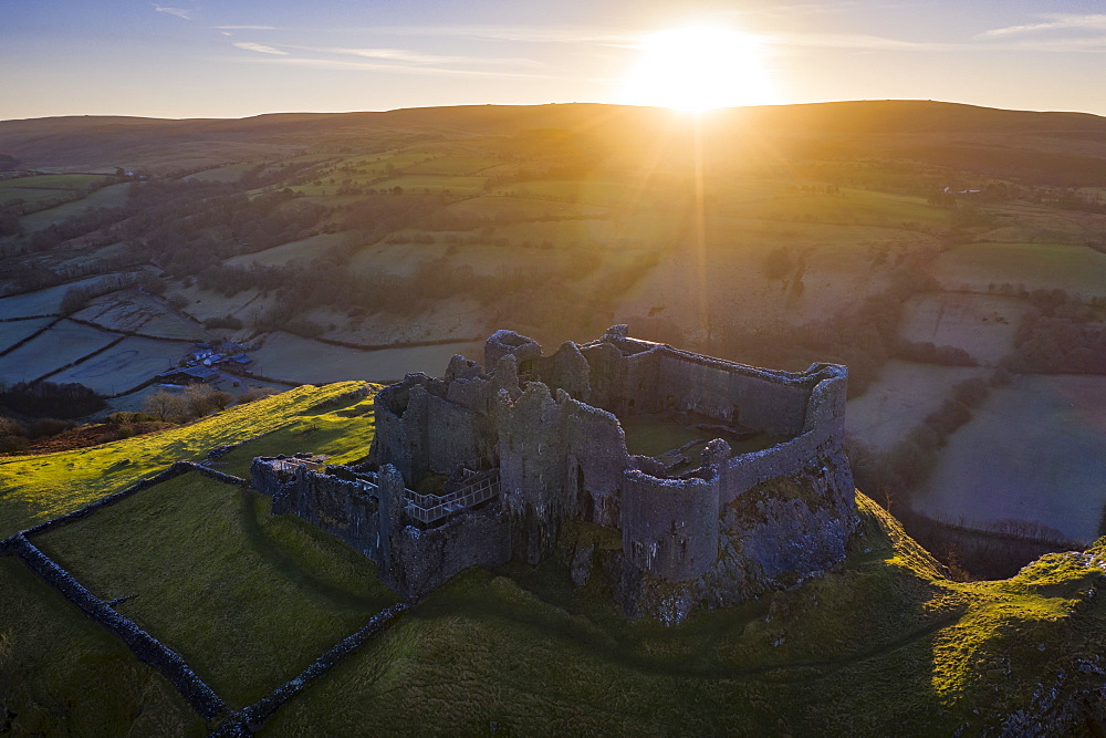 View by drone of sunrise over Carreg Cennen Castle in winter, Brecon Beacons National Park, Carmarthenshire, Wales, United Kingdom, Europe