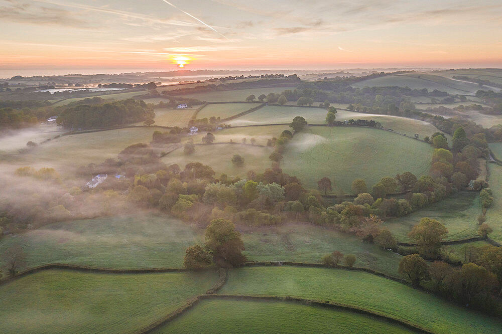 Misty spring sunrise over rolling countryside, South Tawton, Devon, England, United Kingdom, Europe