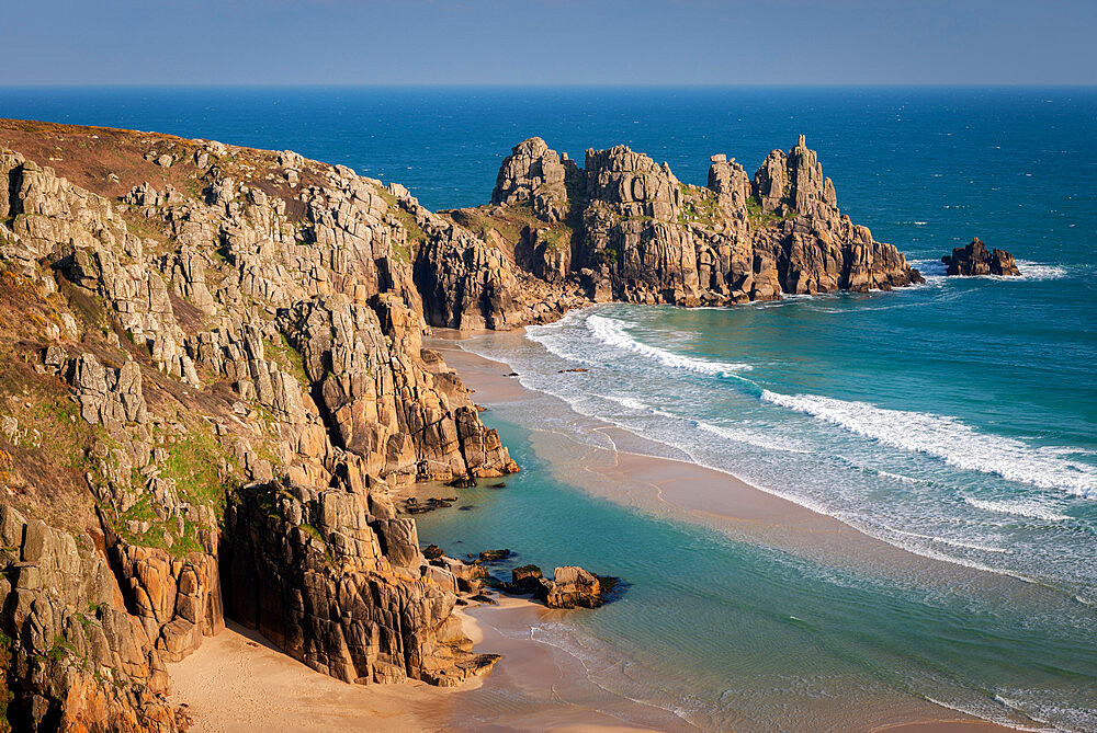 Treryn Dinas and Logan Rock across the beautiful sandy beach at Pedn Vounder, Cornwall, England, United Kingdom, Europe