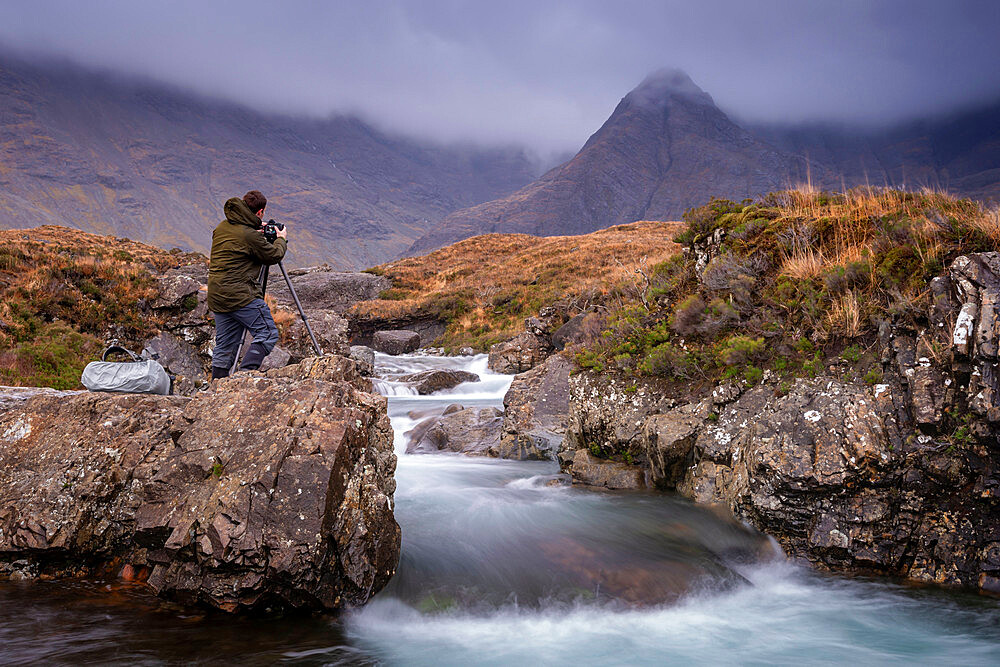 Male photographer at the Fairy Pools on the Isle of Skye, Inner Hebrides, Scotland, United Kingdom, Europe