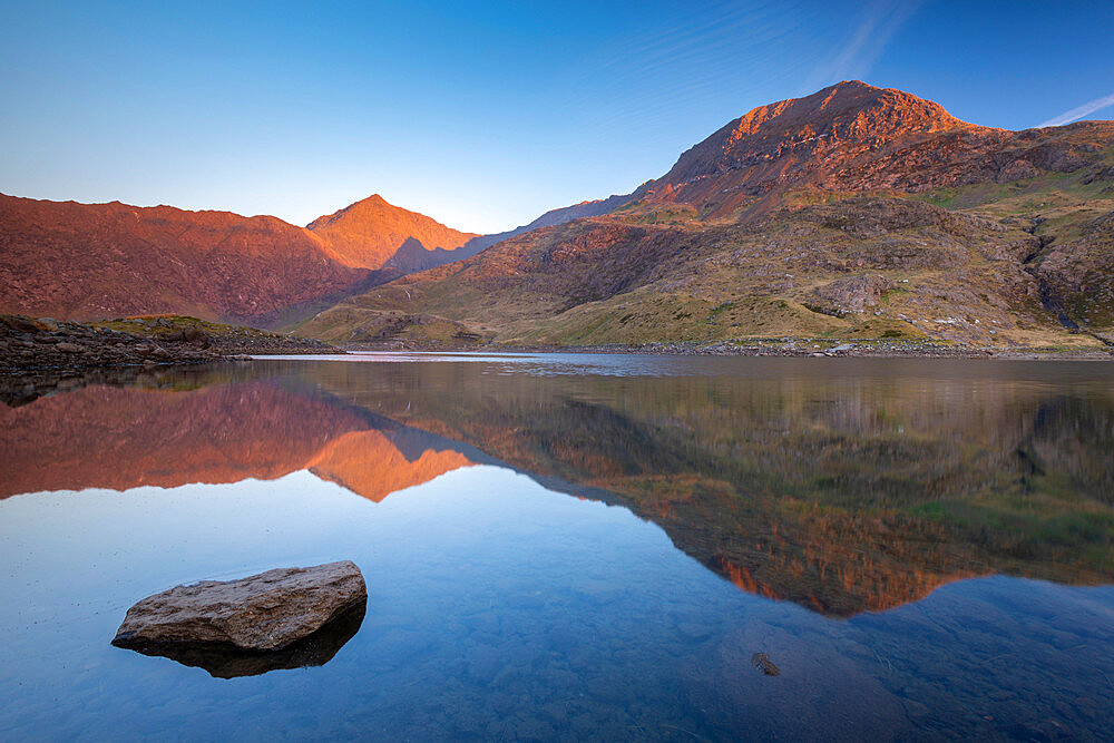 Mount Snowdon bathed in the first light of dawn in spring and reflected in Llyn Llydaw, Snowdonia National Park, Wales, United Kingdom, Europe