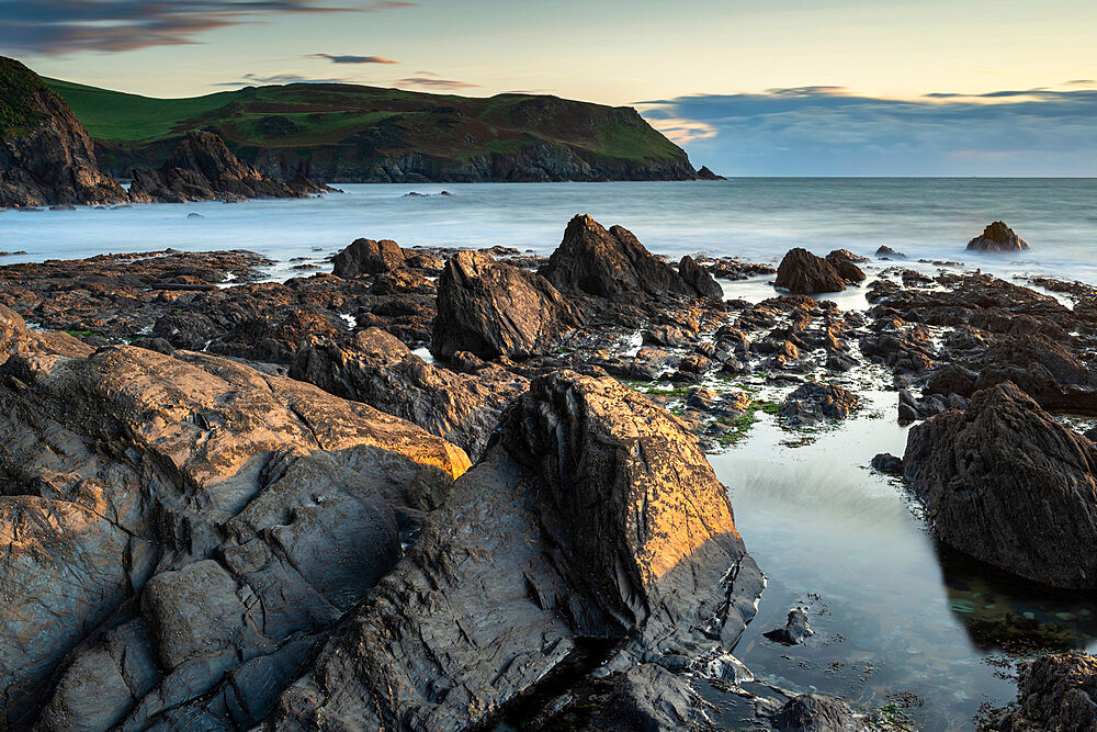 Evening sunlight on the rocky shores of Hope Cove, Devon, England, United Kingdom, Europe