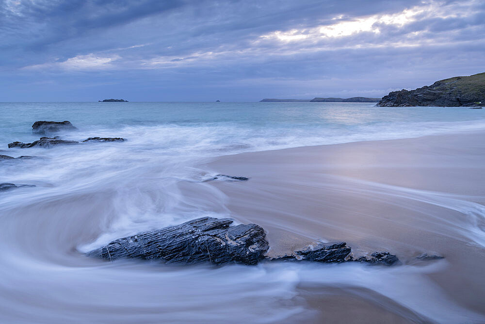 Waves wash over Mother Ivey's Beach at dawn, St. Merryn, Cornwall, England, United Kingdom, Europe