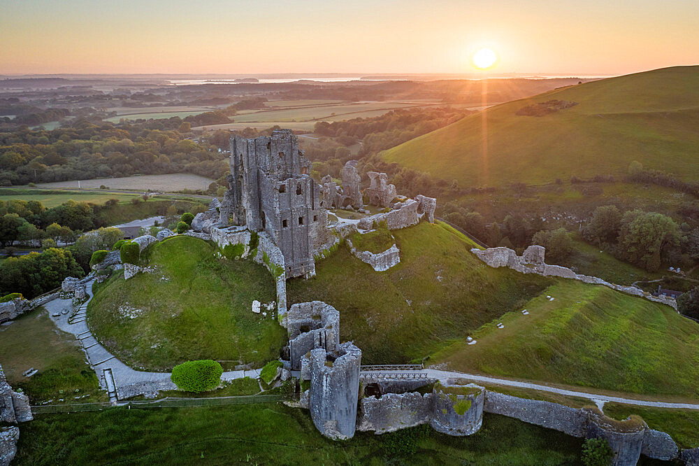 Aerial view of the abandoned ruins of Corfe Castle at sunrise, Dorset, England, United Kingdom, Europe