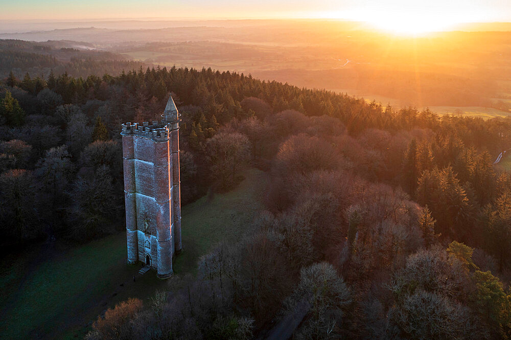 Aerial view of King Alfred's Tower, a folly, at sunset in winter, near Stourhead, Somerset, England, United Kingdom, Europe