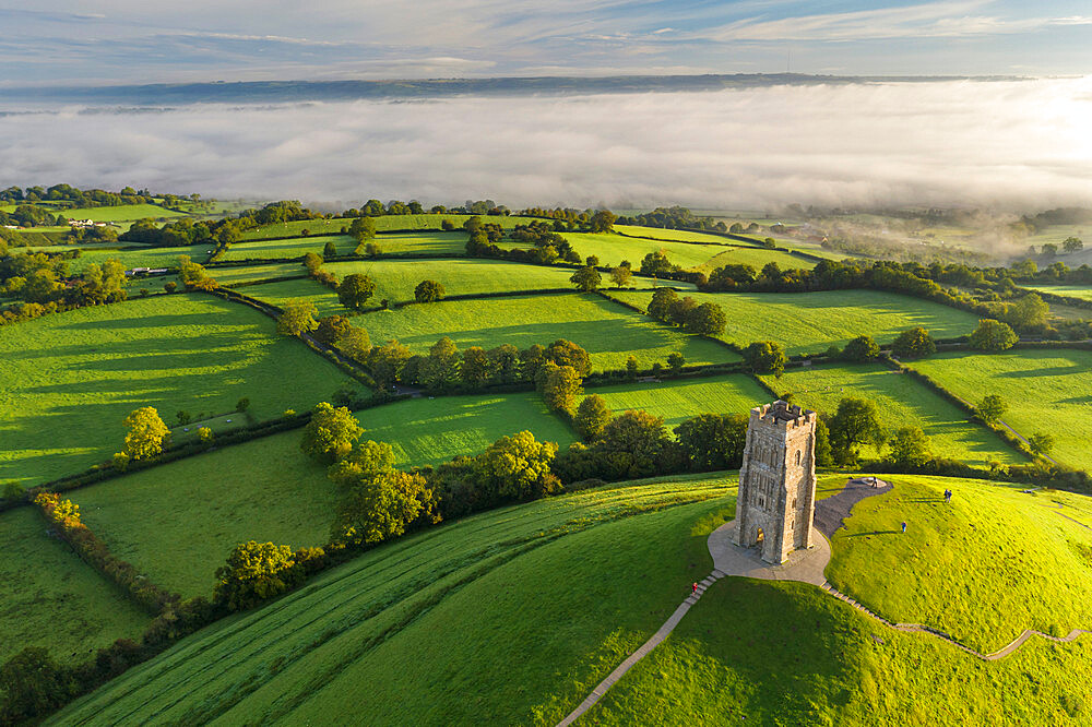 Early morning mists at St. Michael's Tower on Glastonbury Tor in Somerset, England, United Kingdom, Europe