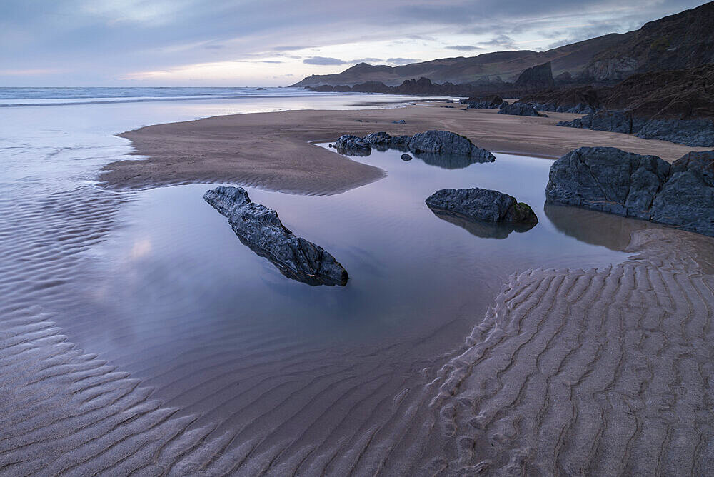 Tidal pools and sand patterns on a deserted Combesgate Beach, North Devon, England, United Kingdom, Europe