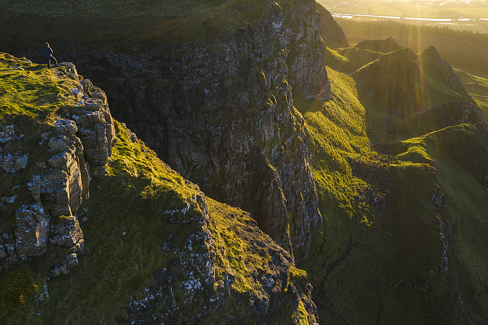 Man standing on the cliff edge of Binevenagh mountain, County Antrim, Ulster, Northern Ireland, United Kingdom, Europe