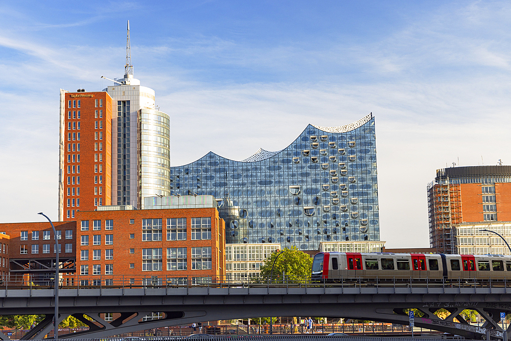 U-Bahn train on tracks with Elbephilharmonie in background, Hamburg, Germany, Europe