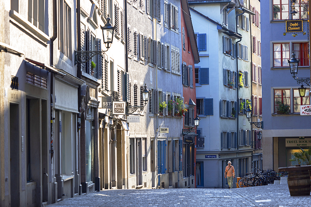 Man walking along street in Old Town, Zurich, Switzerland