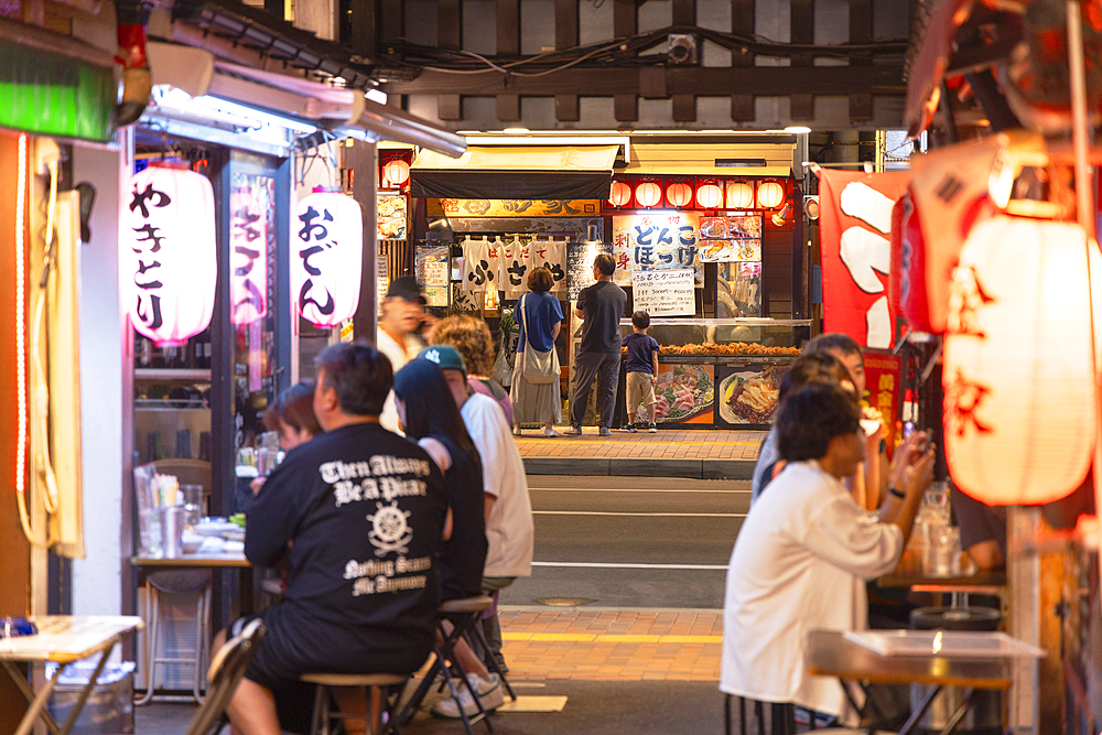 People eating at restaurants in yokocho alley, Hakodate, Hokkaido, Japan
