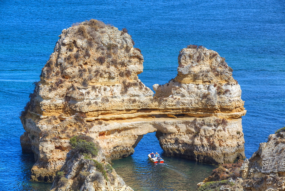 Tourist boat manoeuvering through the Grotos of Ponta da Piedade, Algarve, Portugal, Europe