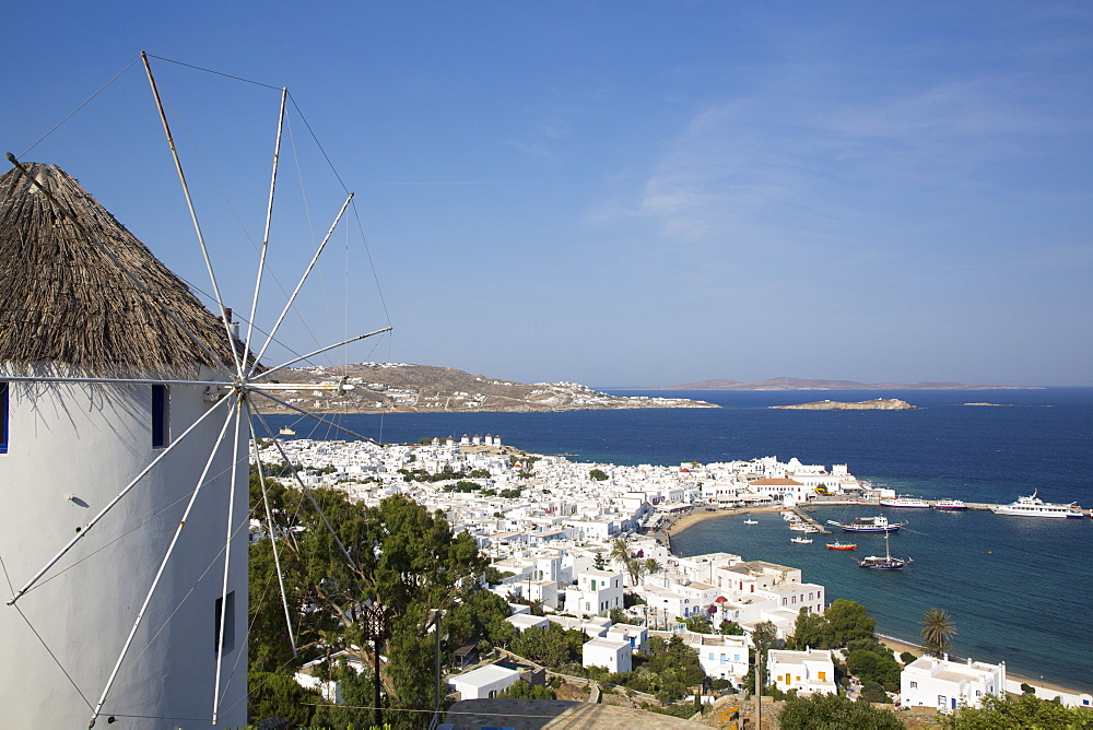 Windmill in foreground, Mykonos Town and Harbor, Mykonos Island, Cyclades Group, Greek Islands, Greece, Europe