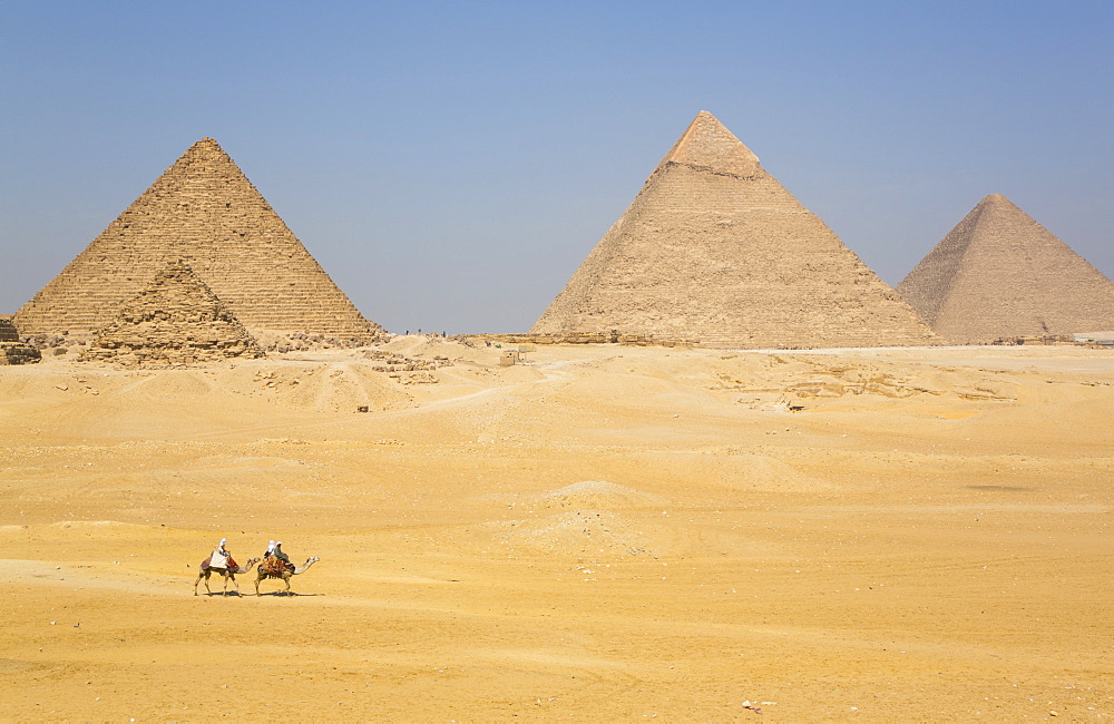 Tourists riding camels, Great Pyramids of Giza, UNESCO World Heritage Site, Giza, Egypt, North Africa, Africa