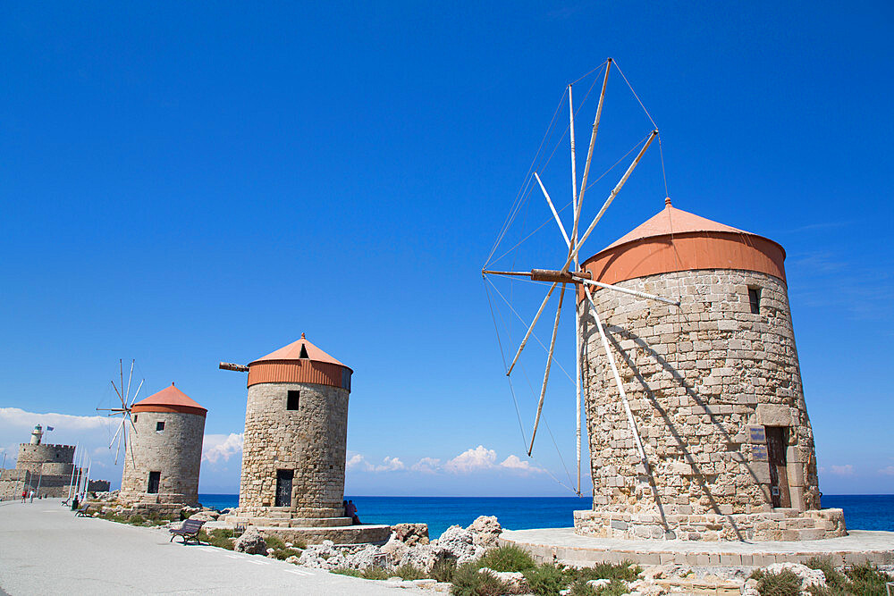 Windmills of Mandraki, Fort of St. Nicholas in the background, Mandraki Harbour, Rhodes, Dodecanese Island Group, Greek Islands, Greece, Europe