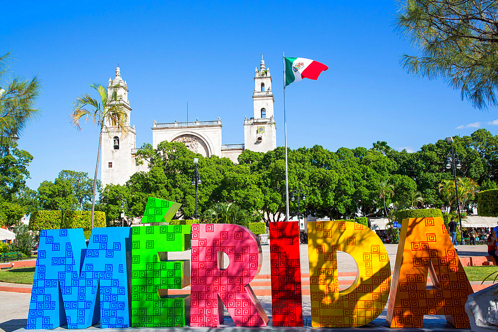 Merida Sign, Mexican flag, Plaza Grande, Cathedral de IIdefonso in the background, Merida, Yucatan State, Mexico, North America