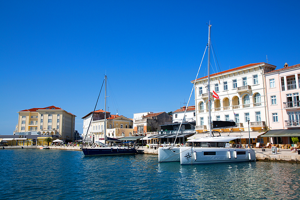 Boats and waterfront restaurants, Harbor, Porec, Croatia, Europe