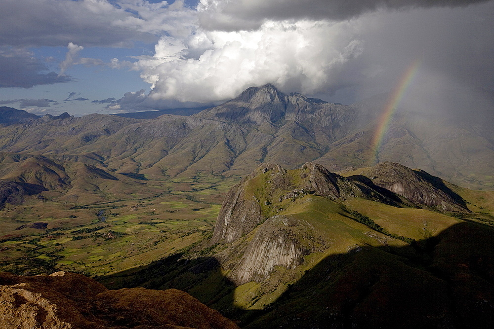 A rainbow appears looking east across the granite mountains of the Andringitra National Park, as a squall of rain blows in from the Indian Ocean, Southern Madagascar, Africa