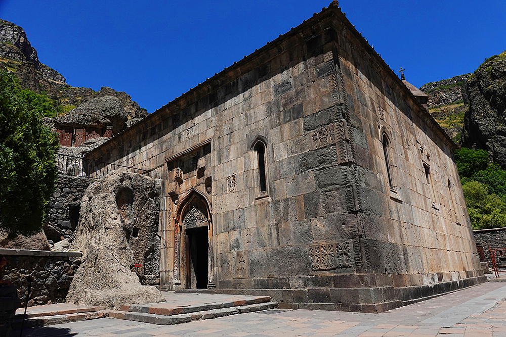 Geghard monastery, a medieval monastery in the Kotayk province of Armenia, is partially carved out of the adjacent mountain and is a UNESCO World Heritage Site. The main chapel was built in 1215, but the monastery complex was founded in the 4th century.