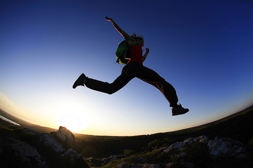 A woman runs in the Mendip Hills, Somerset, England, United Kingdom, Europe