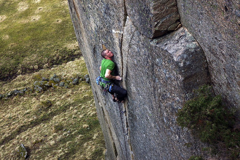 A climber scales cliffs in Bohuslan, western Sweden, Scandinavia, Europe