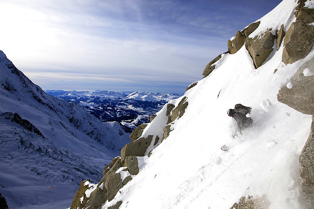 A snowboarder descends an extreme off piste route down Mont Blanc, Chamonix, Haute Savoie, France, Europe