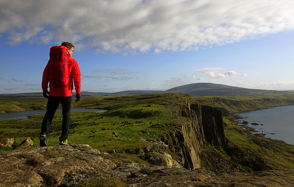 A hiker at Fair Head, County Antrim, Ulster, Northern Ireland, United Kingdom, Europe