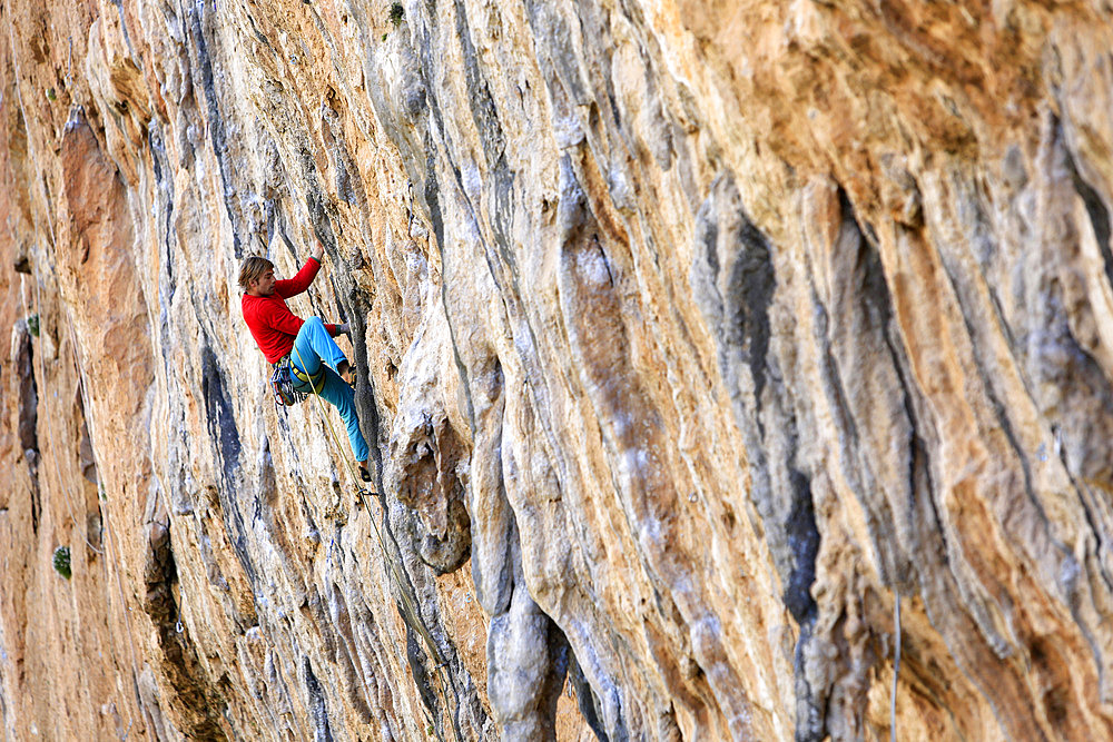 A climber scales cliffs at Chulilla, Valencia, Spain, Europe