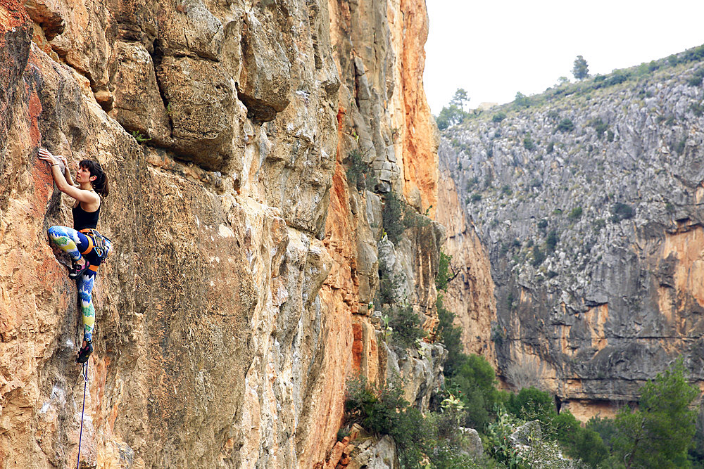 A climber scales cliffs at Chulilla, Valencia, Spain, Europe