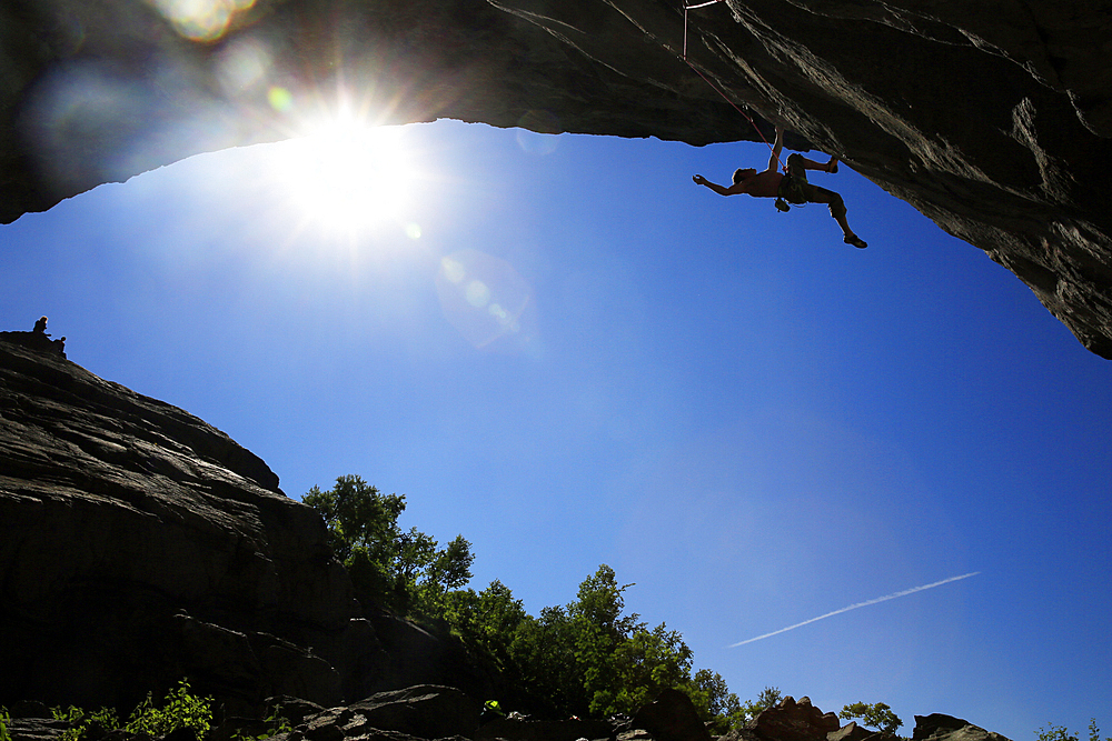 A climber scales a difficult route in the Hanshallaren Cave, Flatanger, Norway, Scandinavia, Europe