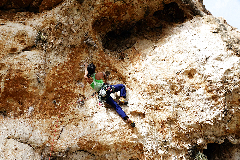 Rock climber in action on the cliffs of Malta, Mediterranean, Europe