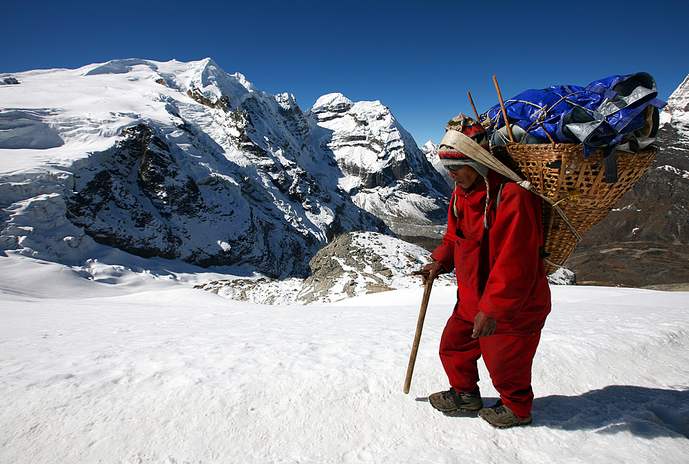 Porter carrying a load on Mera Peak, Solukhumbu, Nepal, Asia