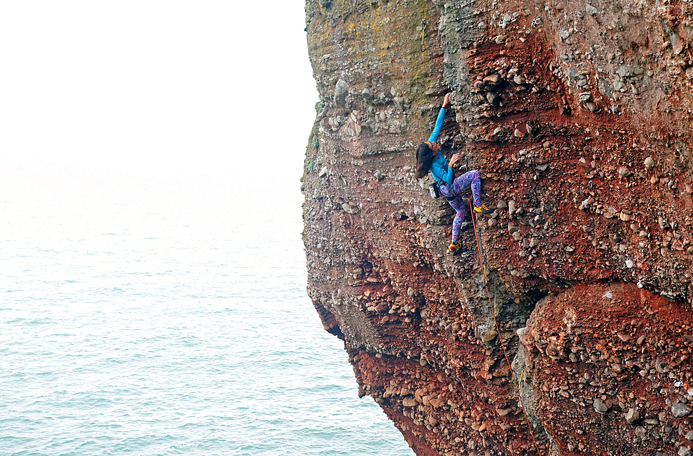 Rock climber in action, Watcombe Beach, South Devon, England, United Kingdom, Europe