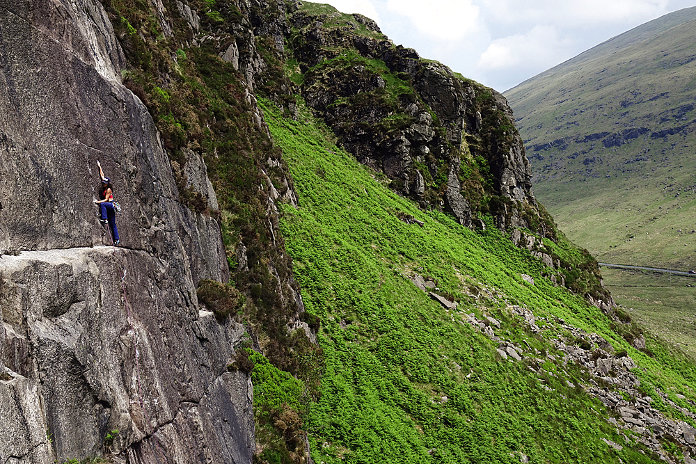 Rock climber in action in the Mourne Mountains, County Down, Ulster, Northern Ireland, United Kingdom, Europe