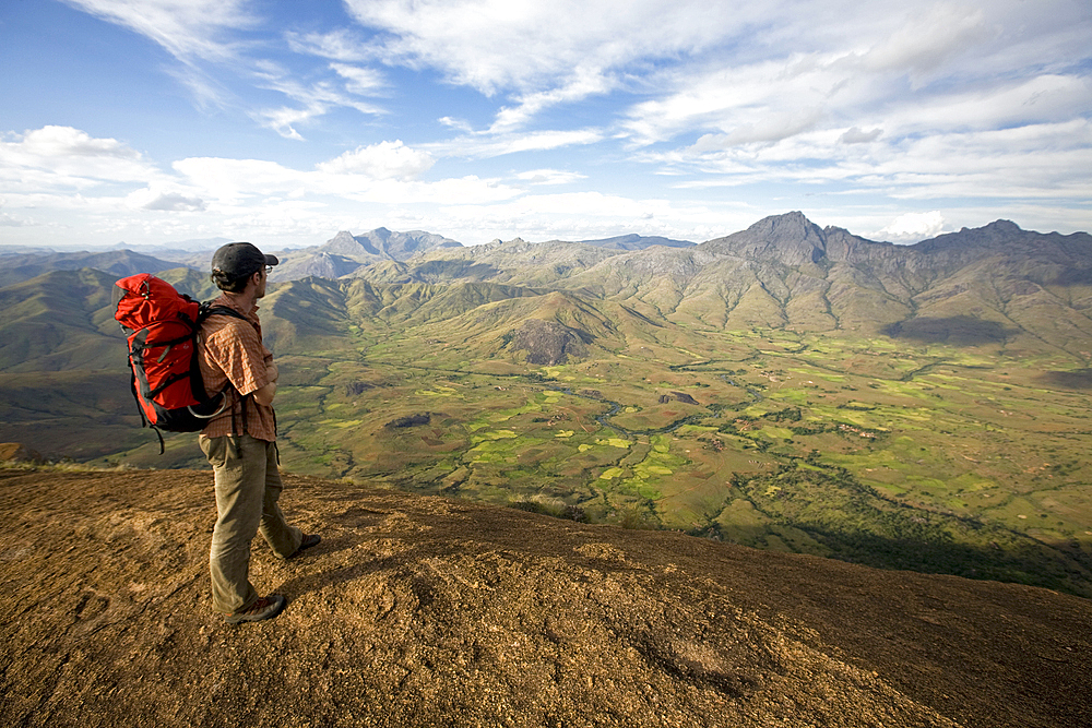 Climber looks across the Tsaranoro Massif, southern Madagascar, Africa