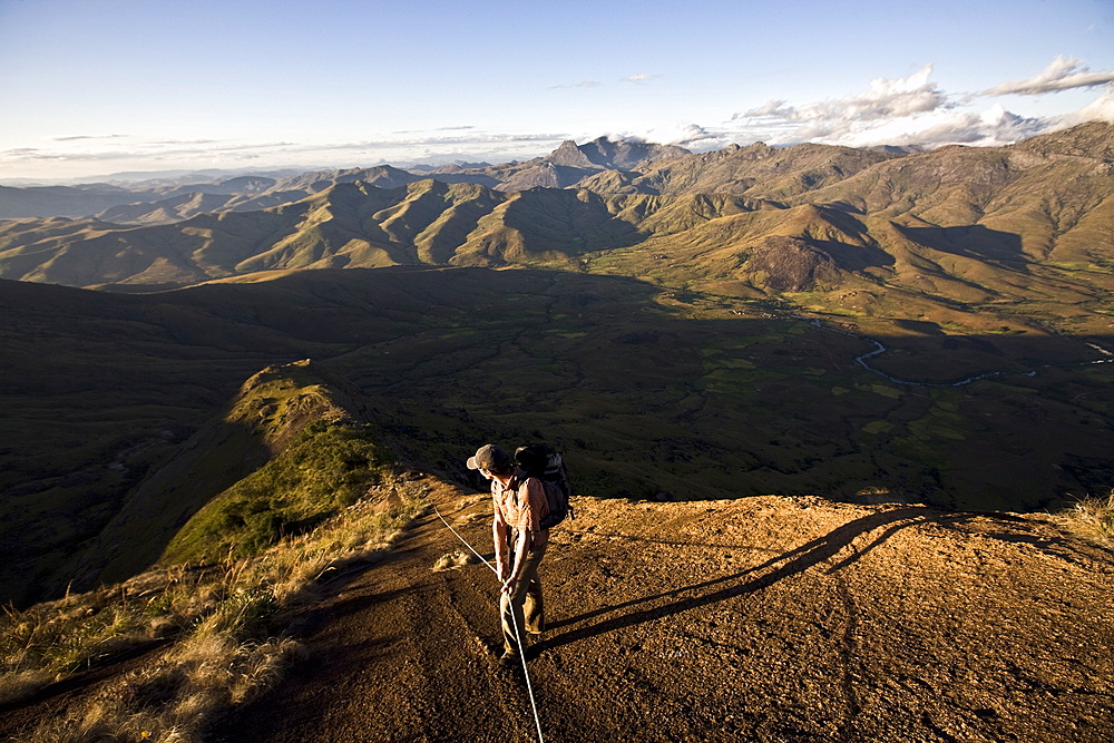 A climber descending a long granite ridge from the upper Tsaranoro Massif, Andringitra National Park, southern Madagascar, Africa